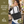 Side-view of woman carrying Small Shoulder Tote, highlighting quilted solid fabric, structured silhouette, and lightweight microfiber construction.