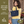 Side-view of woman carrying Small Shoulder Tote, highlighting quilted solid fabric, structured silhouette, and lightweight microfiber construction.