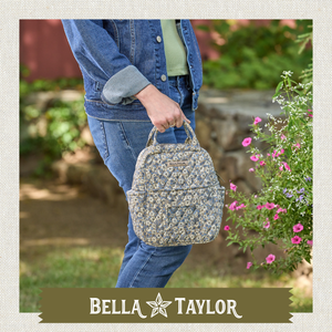 Side-view of woman carrying Lunch Tote highlighting quilted floral fabric and lightweight 100% cotton construction.