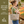 Side-view of woman carrying Small Tote, highlighting quilted floral fabric, structured silhouette, and lightweight 100% cotton construction.
