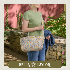 Front-view of woman carrying Claire highlighting quilted floral fabric, structured silhouette, and lightweight 100% cotton construction.