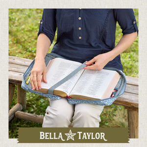 Top-down view of woman holding a Bible cover with Bible inside.
