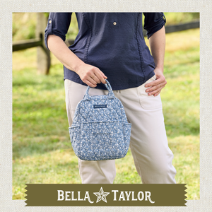 Side-view of woman carrying Lunch Tote highlighting quilted floral fabric and lightweight 100% cotton construction.