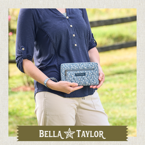 Front-view of woman holding Wrist Strap Wallet made with lightweight 100% cotton construction