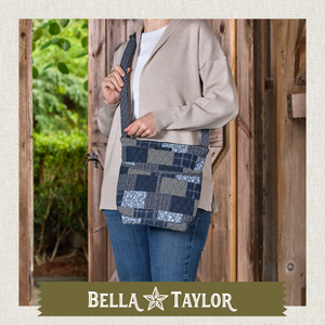 Front-view of woman carrying Hipster highlighting quilted patchwork fabric, structured silhouette, and lightweight 100% cotton construction.