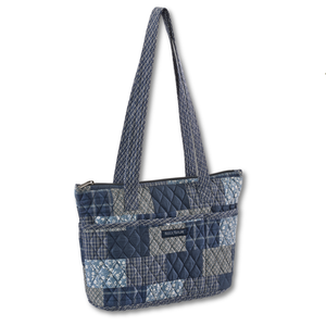 Small Tote front view featuring quilted patchwork print, in warm cream, indigo, & navy, with top zip closure, and 10 total pockets.