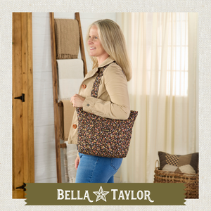 side-view of woman carrying Stride Tote highlighting quilted floral fabric, structured silhouette, and lightweight 100% cotton construction.