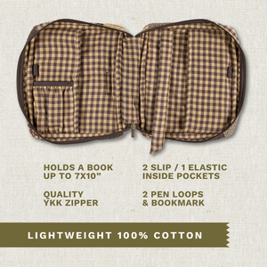 Open top-down view revealing interior with three pockets, two pen loops, YKK zipper, bookmark ribbon, and room for a book up to 7" x 10".