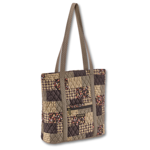 Large Tote front view featuring quilted patchwork fabric in espresso brown, golden tan, soft ivory, and dusty mauve, with top zip closure, and 6 total pockets.