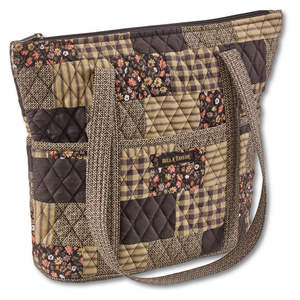 Stride Tote front view featuring quilted patchwork fabric in espresso brown, golden tan, soft ivory, and dusty mauve with top zip closure, and 10 total pockets.