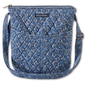 Hipster front view featuring quilted floral fabric in dusty blue, cobalt, & navy, with top zip closure, and 6 total pockets.