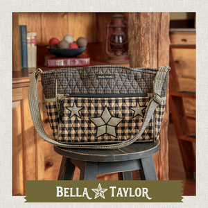 Front-view of woman carrying Claire highlighting quilted patchwork fabric, structured silhouette, and lightweight 100% cotton construction.