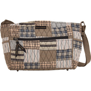 Claire front view featuring quilted patchwork fabric in warm grey, antiqued tan, & vintage white, with top zip closure, and 8 total pockets.