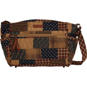 Claire front view featuring quilted patchwork fabric in deep navy, brick red, & khaki, with top zip closure, and 8 total pockets.